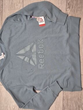 Brand NEW Womens Reebok Crew Neck Sweater In A Goblin Blue Color.